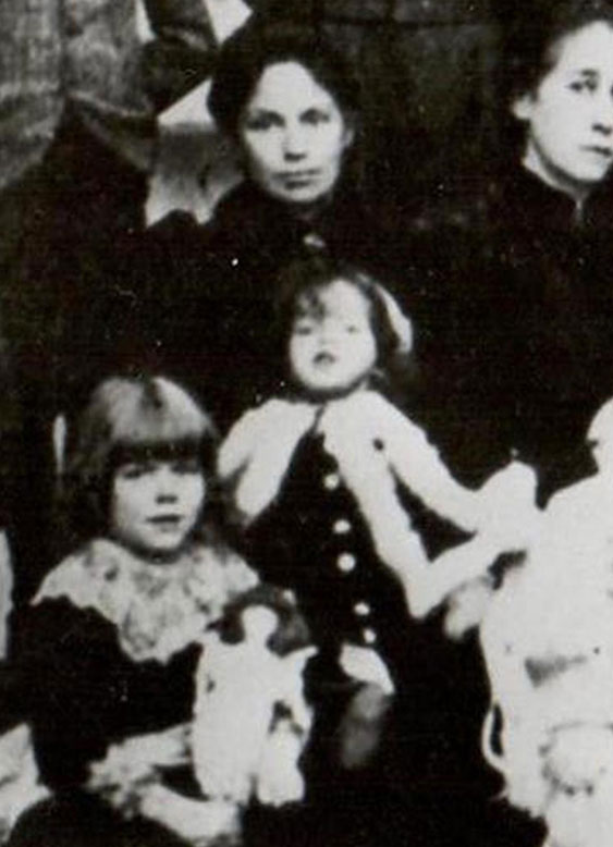 Rosalie sitting on her mother’s lap in a family group photograph in 1894.